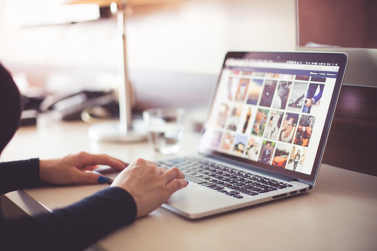 Business owner typing a blog post on laptop