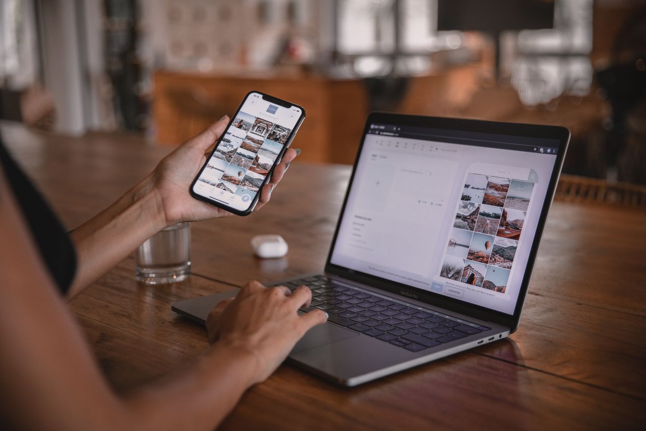 Woman using laptop and smartphone for social content