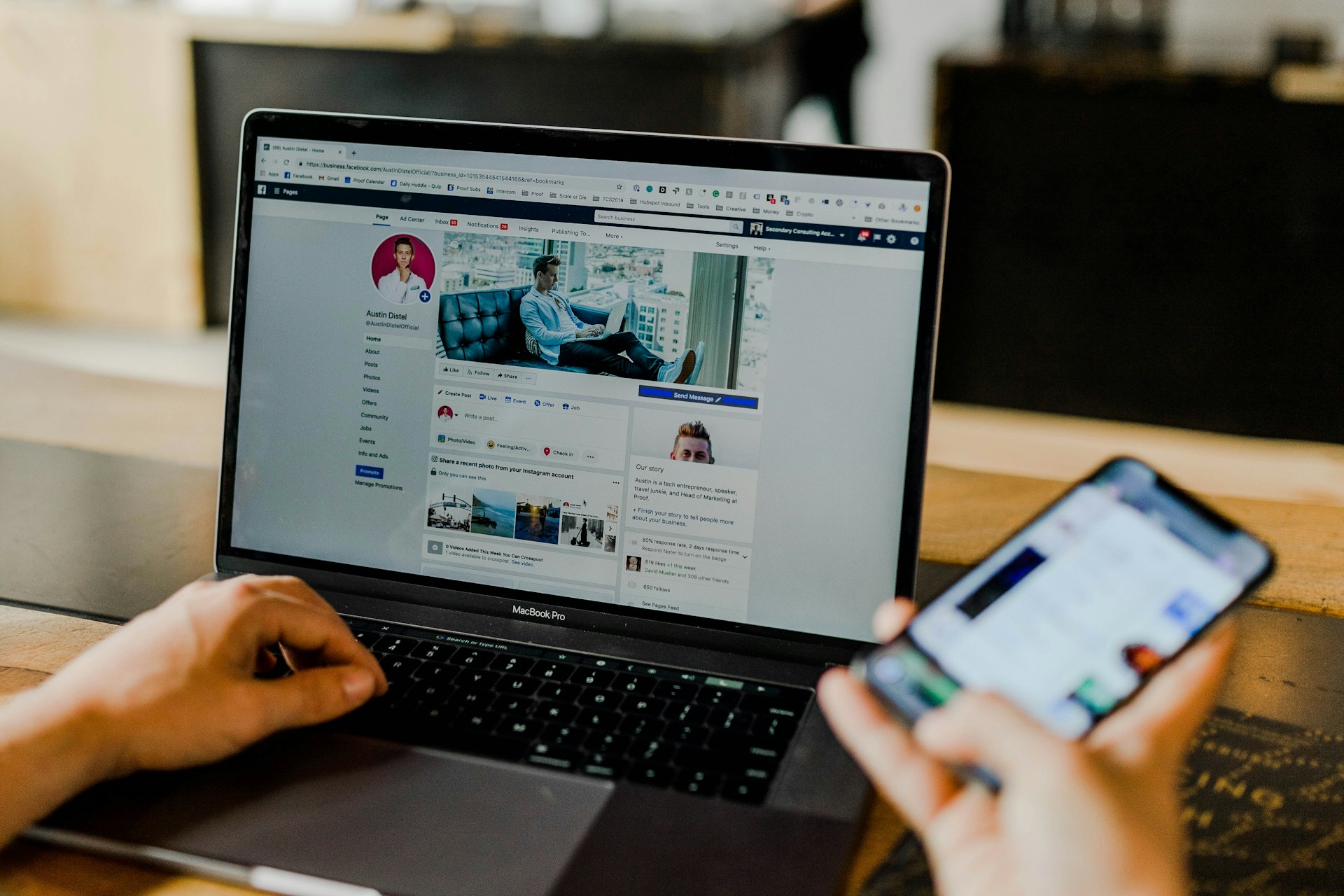 A user is using laptop and phone for social media marketing